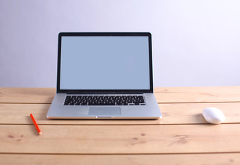 Laptop stands on a wooden table