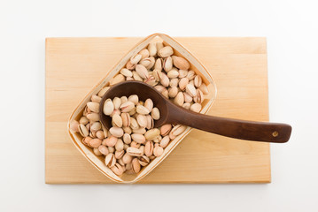 kitchen utensils with wooden containers full of nuts