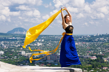 girl flying over city