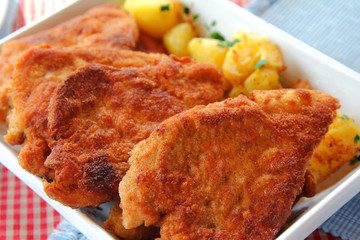 Crispy golden brown color of freshly fried homemade Wiener Schnitzel, national dish of Austria