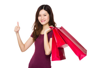 Fototapeta na wymiar Asian Young Woman carry with shopping bag and thumb up