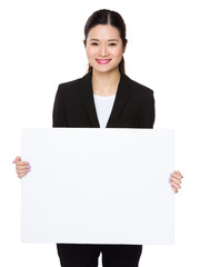 Fototapeta premium Young businesswoman showing with with banner