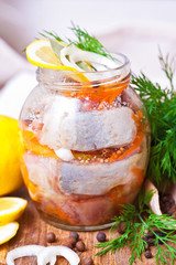 Fototapeta na wymiar Marinated fish in a glass jar