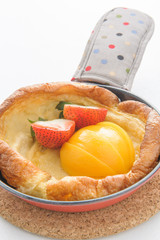 pancakes with fresh fruit in a small pan
