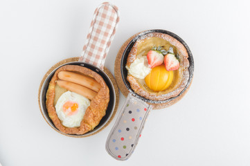 Breakfast of buttermilk pancakes with sausages and fresh berries