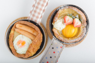 Breakfast of buttermilk pancakes with sausages and fresh berries
