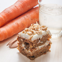 carrot cake with walnuts, prunes and dried apricots on a dark wo