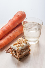 carrot cake with walnuts, prunes and dried apricots on a dark wo