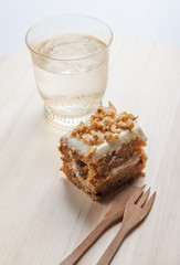 carrot cake with walnuts, prunes and dried apricots on a dark wo