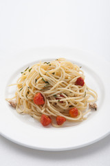 Spaghetti pasta with cherry tomatoes, basil and parmesan cheese, selective focus