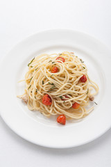 Spaghetti pasta with cherry tomatoes, basil and parmesan cheese, selective focus