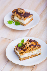 Slice of honey cake on plate and cup of coffee