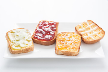 Mix fruit, blueberry, orange fruit jam spread on bread toast ove
