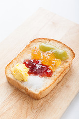 sliced bread with jam on wood background
