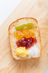 sliced bread with jam on wood background