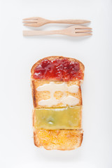 Mix fruit, blueberry, orange fruit jam spread on bread toast ove