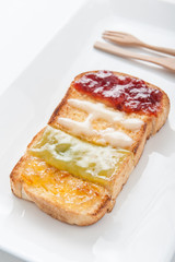 Mix fruit, blueberry, orange fruit jam spread on bread toast ove