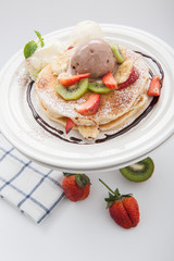 The Original pancakes with banana,ice cream and whipped cream on