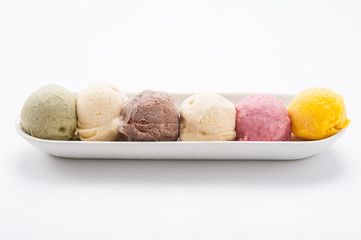 Mixed ice creams in bowl on white background