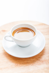 Cup of espresso with coffee beans