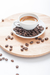 Cup of espresso with coffee beans