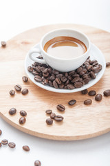 Cup of espresso with coffee beans