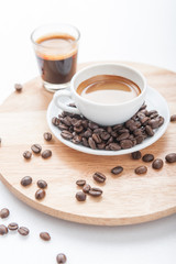 Cup of espresso with coffee beans