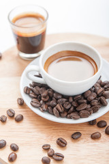 Cup of espresso with coffee beans