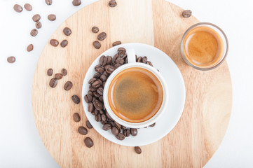Cup of espresso with coffee beans