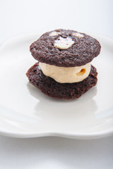 brownie dessert with ice cream on a white plate.