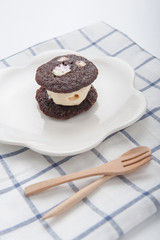 brownie dessert with ice cream on a white plate.