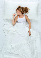 Fototapeta na wymiar Beautiful young women lying on bed