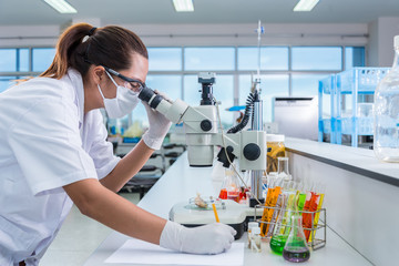 Serious clinician studying chemical element on tester and lectur