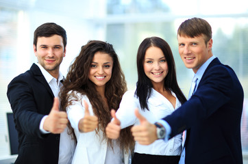 Happy business team with thumbs up in the office