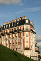 Fototapeta na wymiar PARIS, FRANCE - NOVEMBER 27, 2009: Residential building on Montmartre near Basilica of the Sacred Heart of Paris