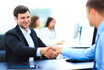 Fototapeta premium Business people shaking hands, finishing up a meeting