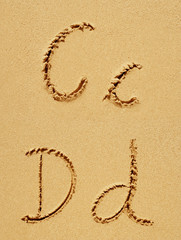 Sand font or letter set or collection on an exotic beach near the sea in summer
