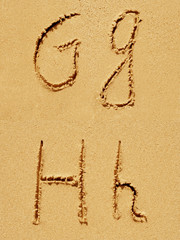 Sand font or letter set or collection on an exotic beach near the sea in summer