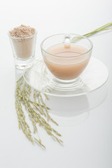 Rice milk in glass and rice crop isolated on white background. V