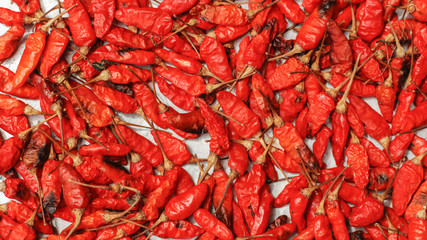 Hot dried red chillies as a textured food background.