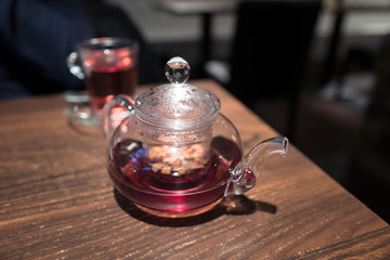 Teapot with fresh hot tea on table