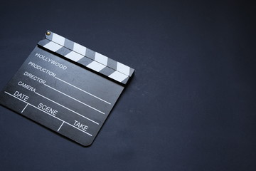 still life on a blue background of clapperboard to work on cinema and movie