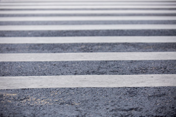 Fototapeta premium Empty urban pedestrian crosswalk in black and white across an asphalt street in downtown.
