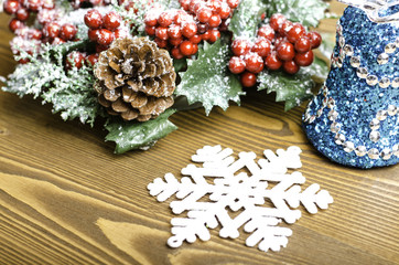 Obraz na płótnie Canvas Christmas wreath with pine cones, bell and snowflake.