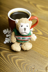 Cup of coffee, snowflake and toy monkey.