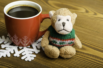Cup of coffee, snowflake and toy monkey.