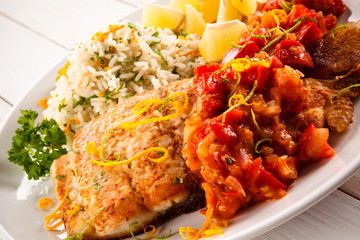 Fish dish - fried fish fillet white rice and vegetables 