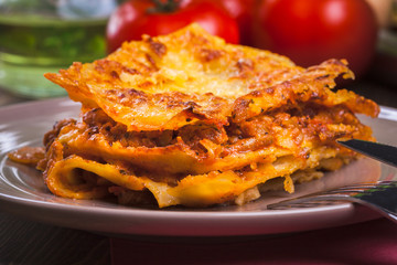 Piece of tasty hot lasagna on a plate