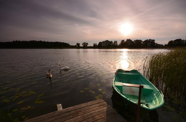 evening landscape with green boat