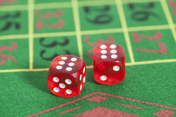 roll of the red dice on a game table in  casino